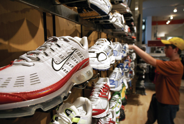 A customer shops for athletic shoes at a Nike store.