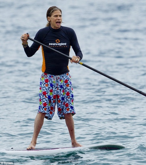 Description: Master of the waves: Rocker Steven Tyler navigated his paddleboard with ease as he negotiated the waves in Hawaii